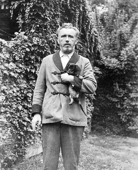 A gentleman in a smoking jacket smoking a cigarette (1930).
