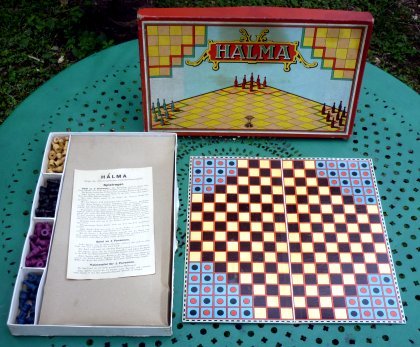A halma board, box, and pieces.